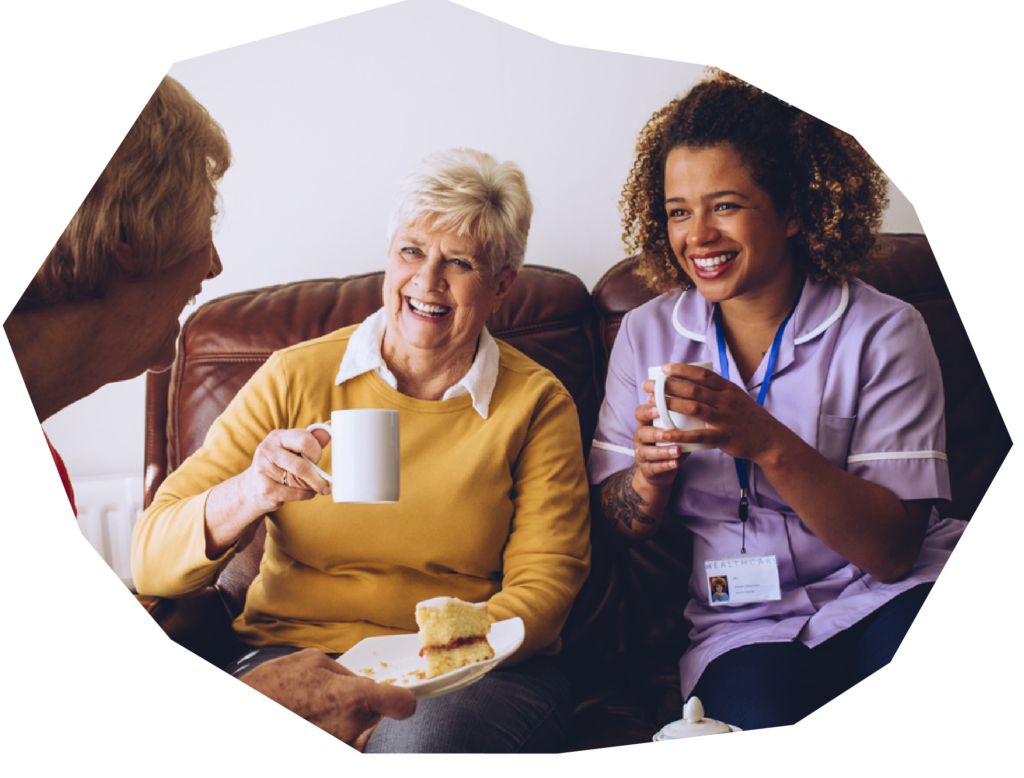 Carerworker staff having a coffee with clients family