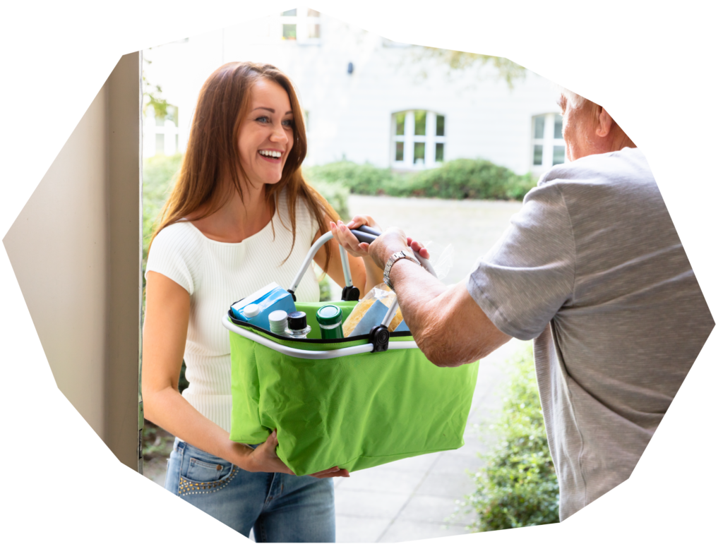 A female careworker handing shopping bag to a client